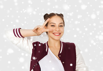 Image showing happy smiling teenage girl showing peace sign