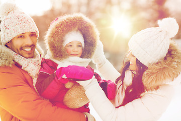 Image showing happy family with child in winter clothes outdoors