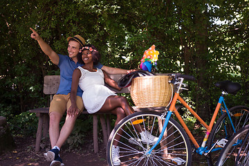 Image showing Young  couple having joyful bike ride in nature