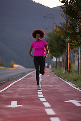 Image showing a young African American woman jogging outdoors