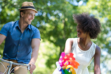 Image showing Young  couple having joyful bike ride in nature