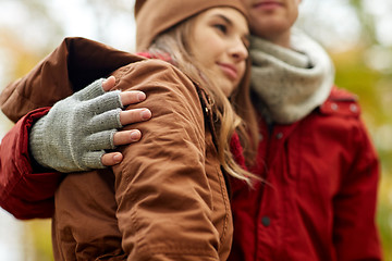 Image showing close up of happy couple hugging in autumn park