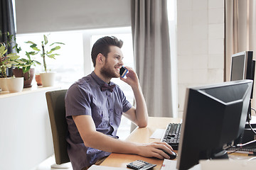 Image showing happy creative male worker calling on smarphone