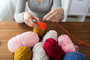 Image showing woman pulling yarn up into ball