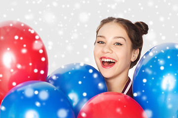 Image showing happy teenage girl with helium balloons over snow