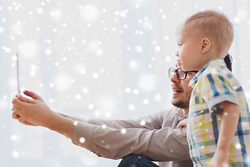 Image showing father and son with tablet pc playing at home