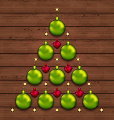 Image showing Christmas tree made of baubles on wooden background