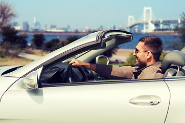 Image showing happy man driving cabriolet car in tokyo