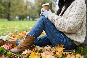 Image showing close up of  woman drinking coffee in autumn park