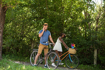 Image showing Young  couple having joyful bike ride in nature