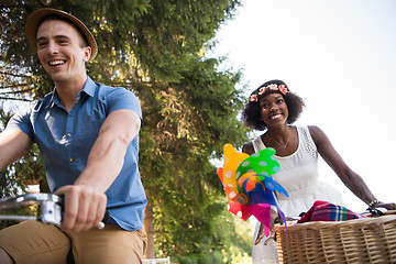 Image showing Young  couple having joyful bike ride in nature