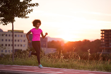 Image showing a young African American woman jogging outdoors