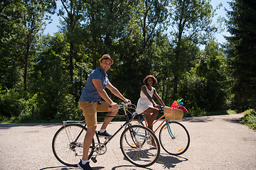 Image showing Young  couple having joyful bike ride in nature
