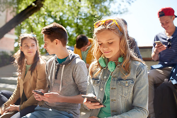 Image showing teenage friends with smartphone and headphones