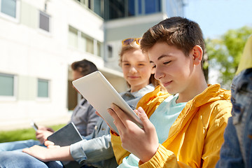 Image showing happy friends or students with tablet pc outdoors