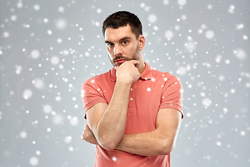 Image showing man thinking over snow background