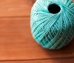 Image showing close up of turquoise knitting yarn ball on wood