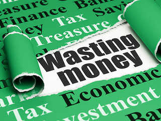 Image showing Money concept: black text Wasting Money under the piece of  torn paper