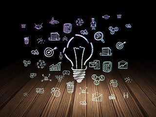 Image showing Finance concept: Light Bulb in grunge dark room