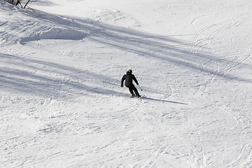 Image showing Skier on ski slope at sun winter day