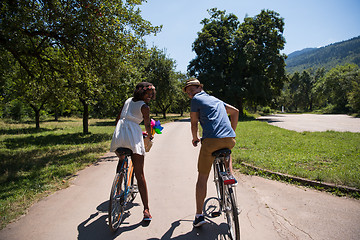 Image showing Young  couple having joyful bike ride in nature