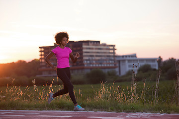 Image showing a young African American woman jogging outdoors