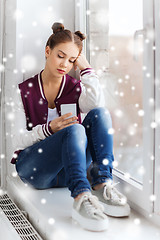 Image showing sad pretty teenage girl with smartphone texting