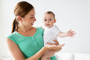 Image showing happy young mother with little baby at home