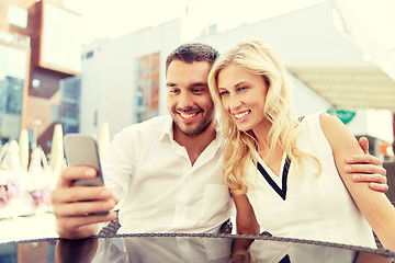 Image showing couple taking selfie with smatphone at restaurant