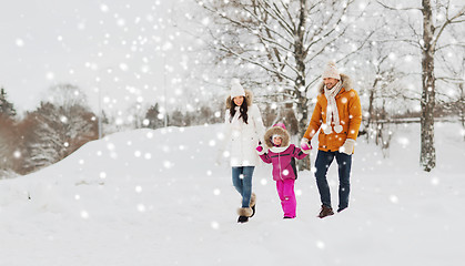 Image showing happy family in winter clothes walking outdoors