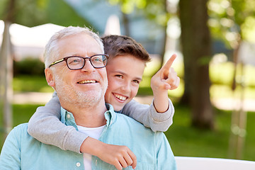 Image showing grandfather and boy pointing finger at summer park