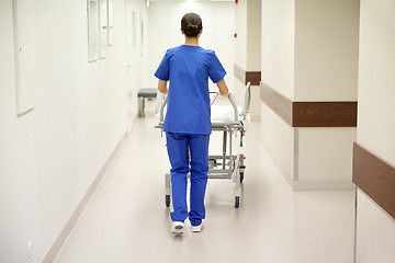 Image showing nurse carrying hospital gurney to emergency room