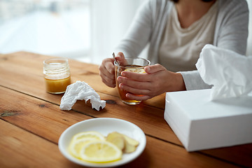 Image showing ill woman drinking tea with lemon and honey