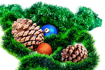 Image showing Green Christmas tinsel, Christmas-tree balls and pine cones 