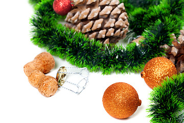Image showing Christmas tinsel, Christmas-tree balls, pine cones and champagne