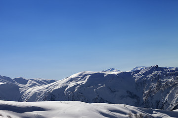 Image showing Off-piste slope and blue clear sky in sun morning