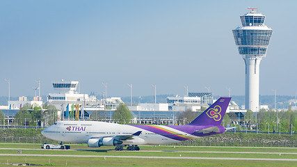 Image showing Jet airliner Thai Airways International airlines taxiing on push