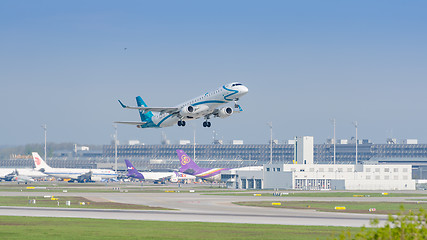 Image showing Plane Embraer E-Jet of Air Dolomiti airlines gaining altitude