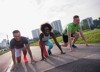 Image showing multiethnic group of people on start position for jogging