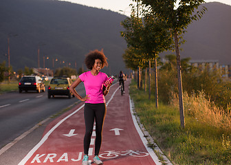 Image showing Portrait of a young african american woman running outdoors