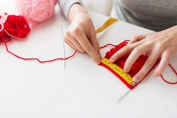 Image showing woman with knitting, needles and measuring tape