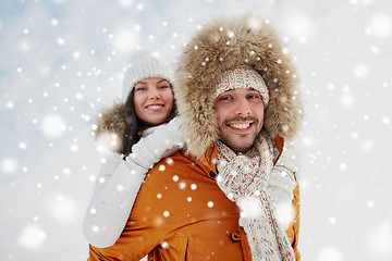 Image showing happy couple having fun over winter background