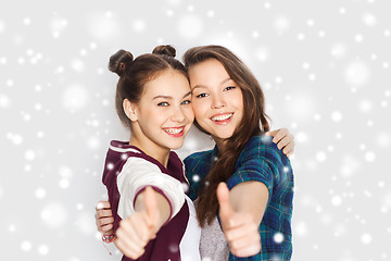 Image showing happy smiling teenage girls showing thumbs up