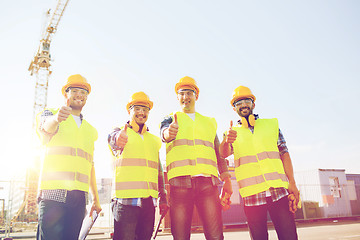 Image showing group of smiling builders with tablet pc outdoors