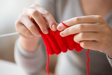 Image showing close up of hands knitting with needles and yarn