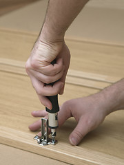 Image showing Hands with a screwdriver