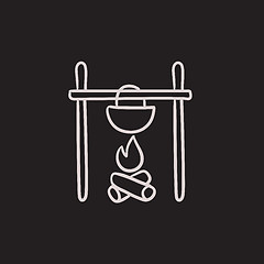 Image showing Cooking in cauldron on campfire sketch icon.