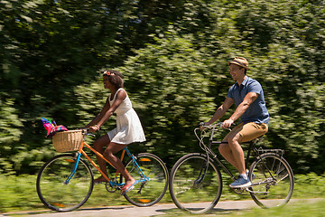 Image showing Young  couple having joyful bike ride in nature