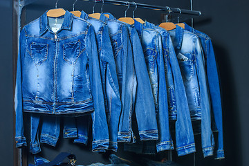 Image showing fashion jeans jacket on hangers 