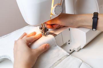 Image showing Portnaya tailoring fabric on sewing-machine